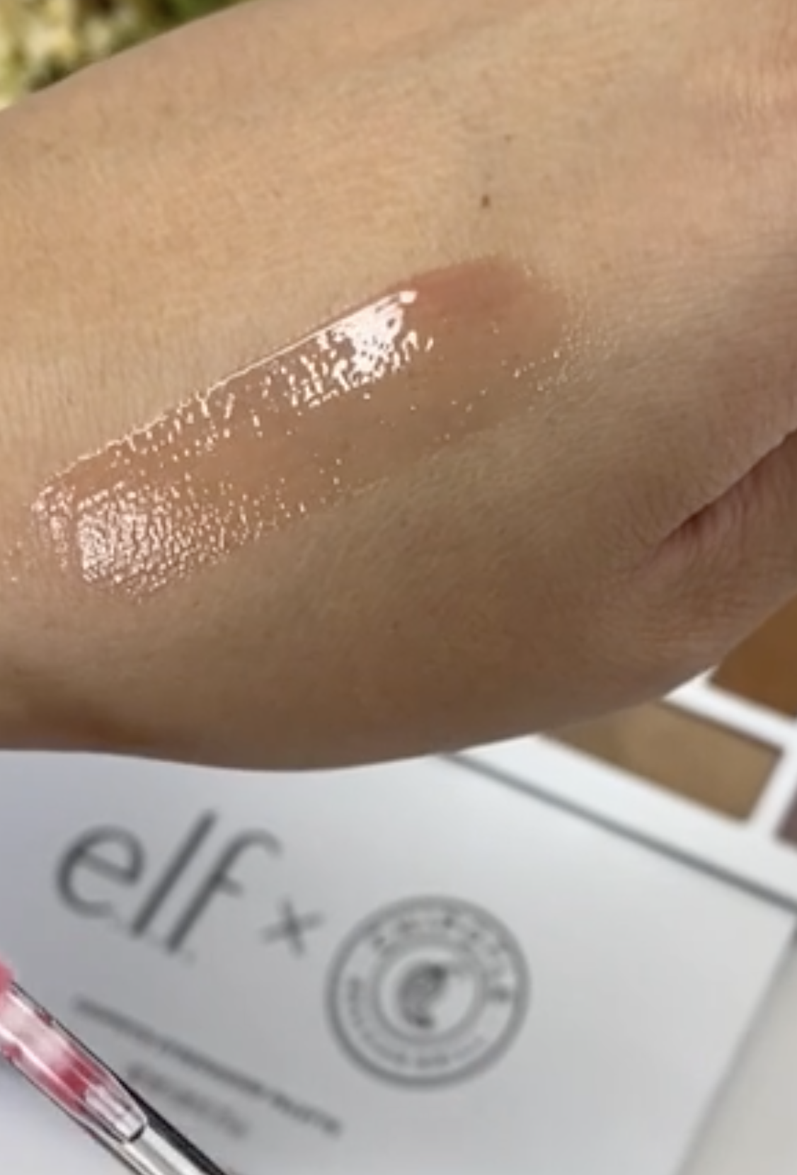 A transparent red sheer gloss on a person&#x27;s hand