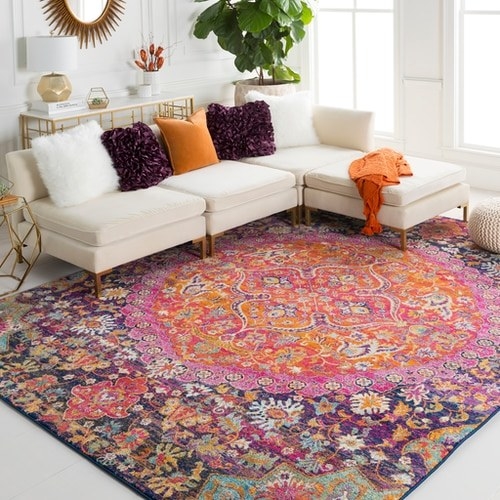 the bright pink, purple, orange, mint, and white floral pattern rug in a living room