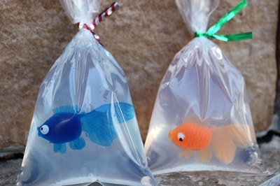 two soaps in bags with plastic goldfish inside 