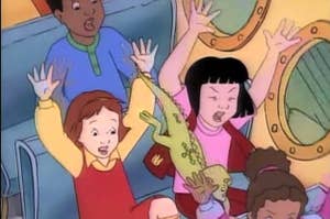 The students from "The Magic School Bus" screaming with their arms in the air while riding the school bus