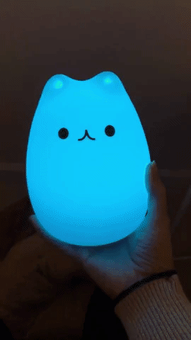 Gif of reviewer holding cat-shaped light switching colors
