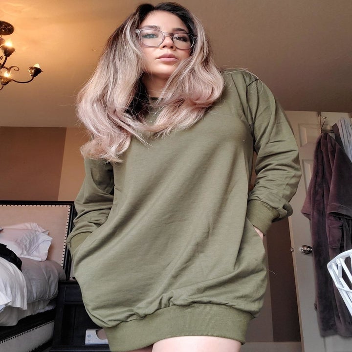 Reviewer wearing olive green tunic