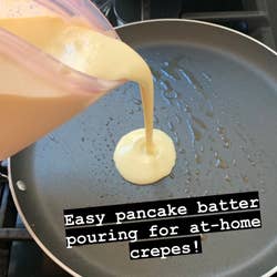 Pouring crepe batter out of the container easily into a greased pan