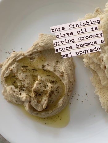 A photo of hummus with olive oil drizzled on top and text 