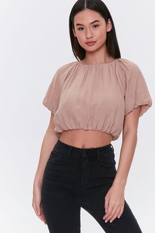 Model wearing the crop top in the color Taupe