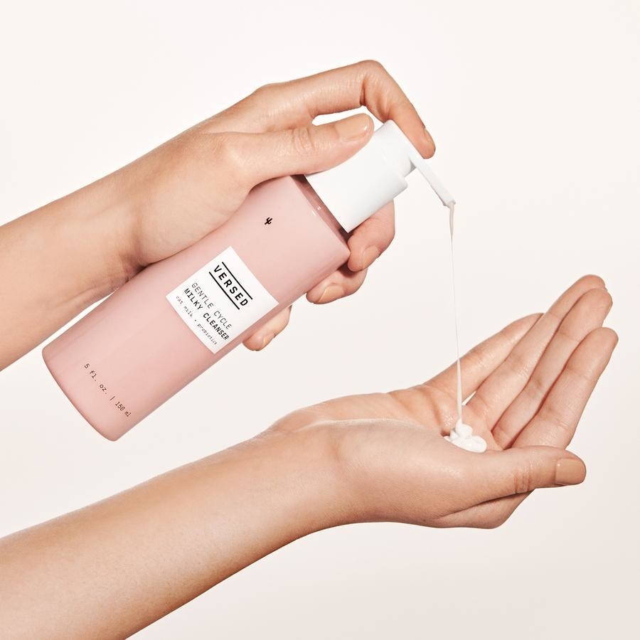 model pumping white, thick cleanser into their hand