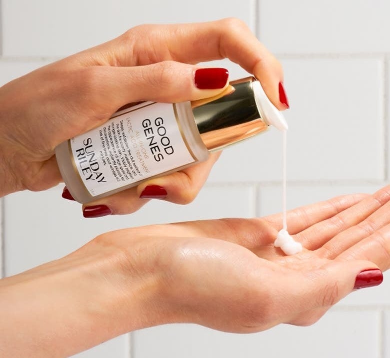 model holding the serum in their hand