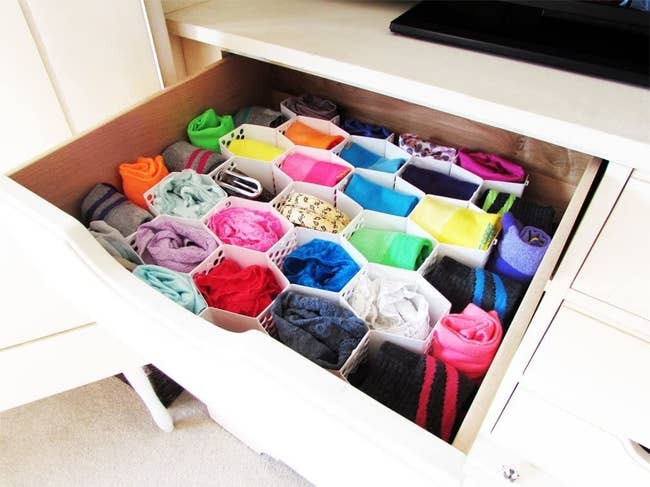 a drawer with the organizer in it and sorted socks and underwear 