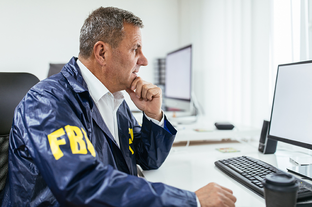 An FBI agent looking at a computer screen