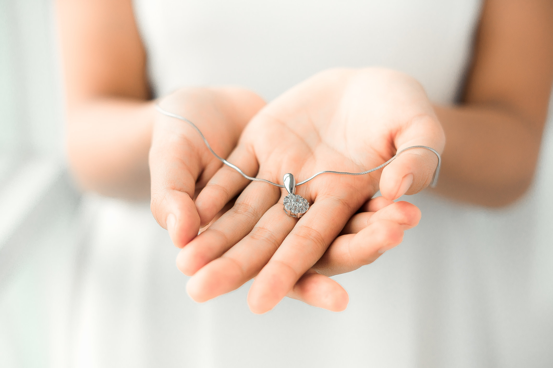 Person holding a necklace