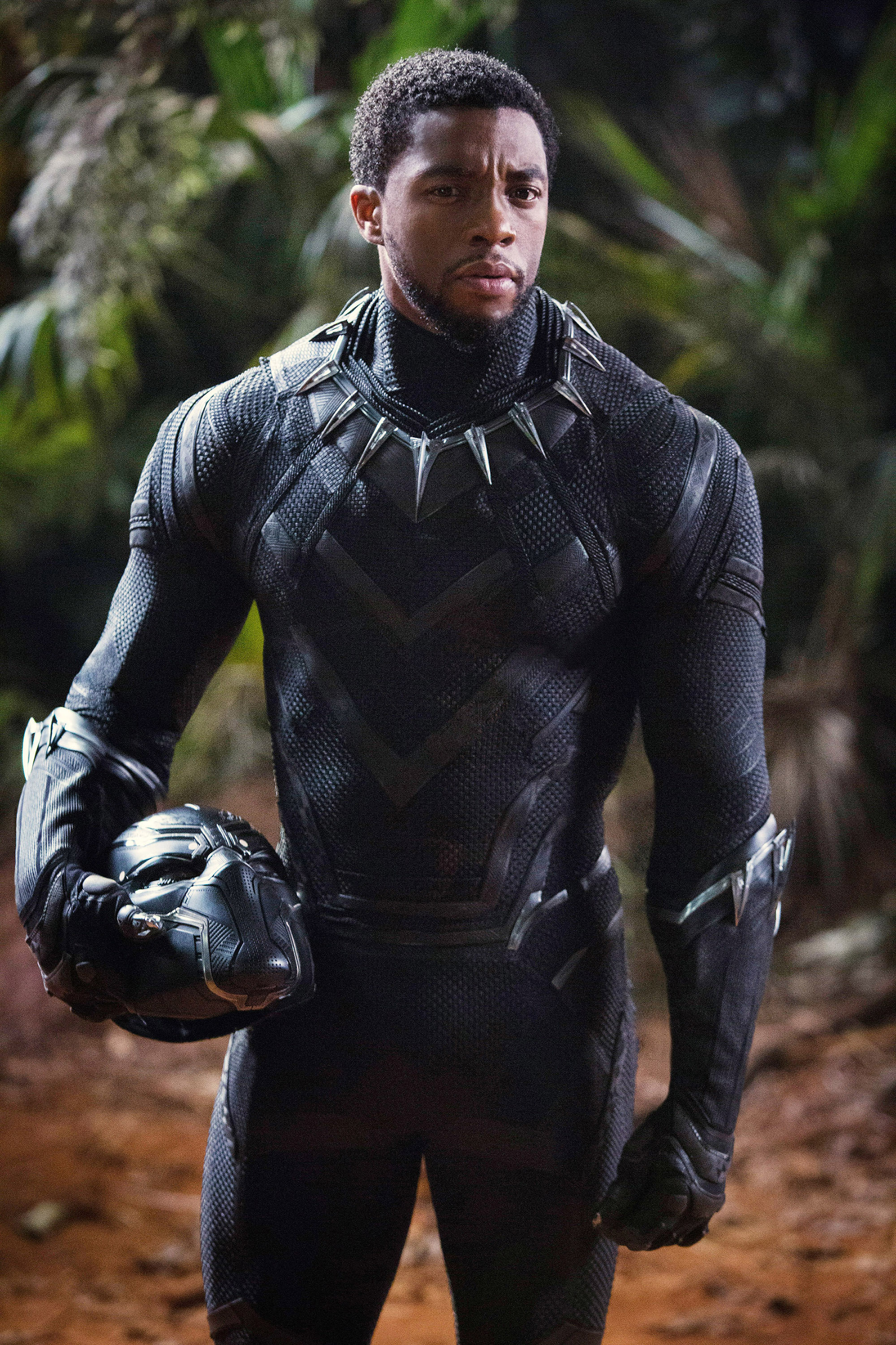 Chadwick Boseman as Black Panther holding his helmet