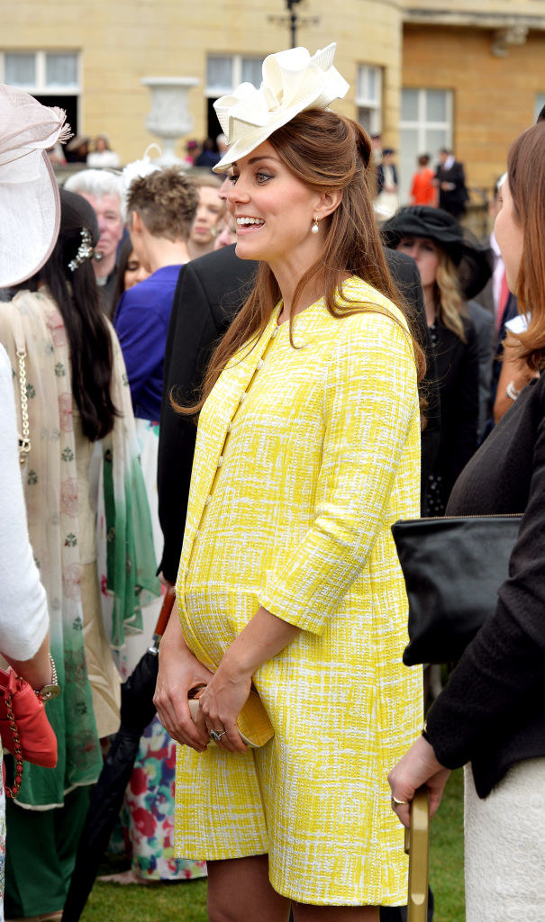 Kate Middleton having a conversation at an event during her pregnancy