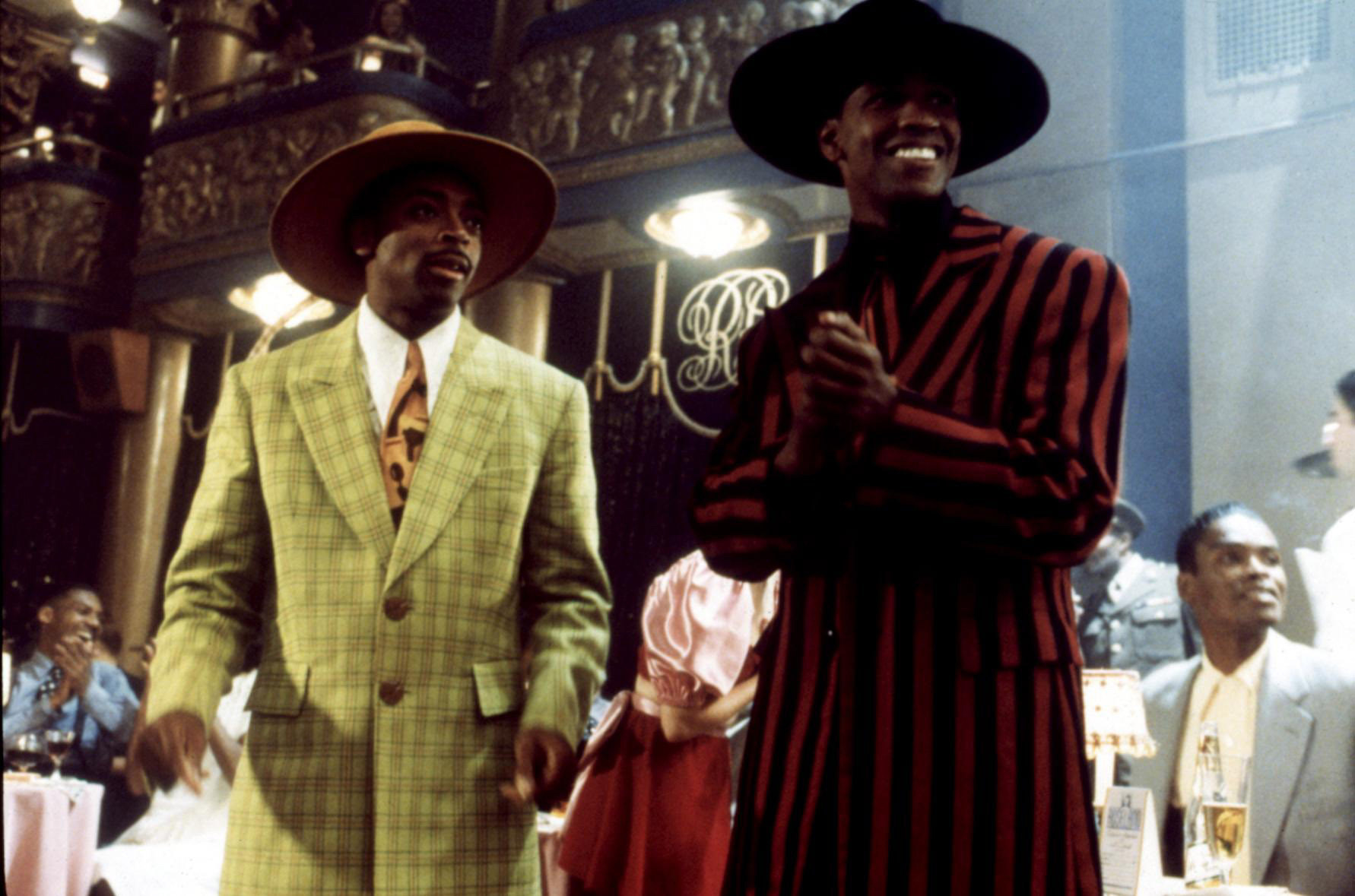 Spike Lee and Denzel Washington wearing zoot suits and matching hats in a scene from Malcolm X