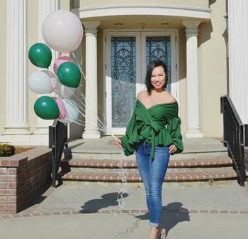 reviewer wearing the green version paired with jeans and heels