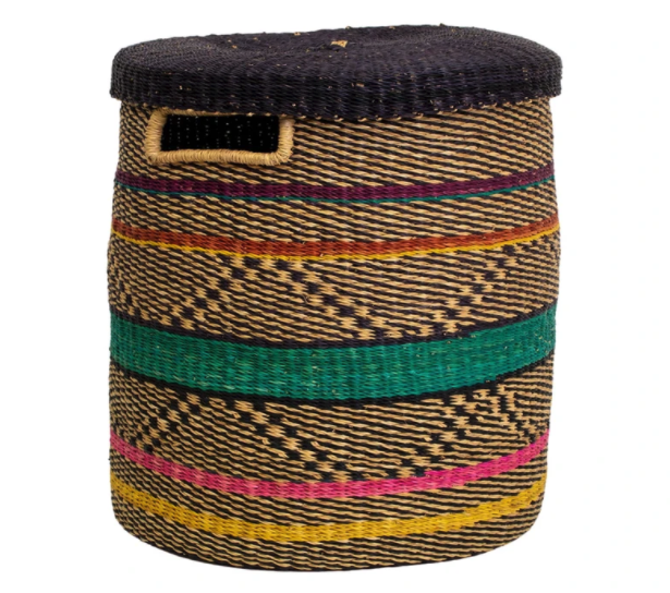 the woven hamper is a mix of tan, yellow, green, pink, and blue line designs 