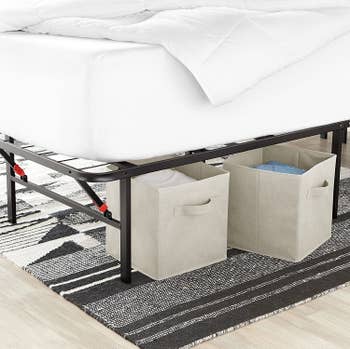 Two beige storage cubes placed underneath bed