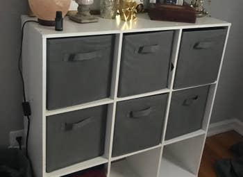reviewer's cube bookcase with the gray bins in it 