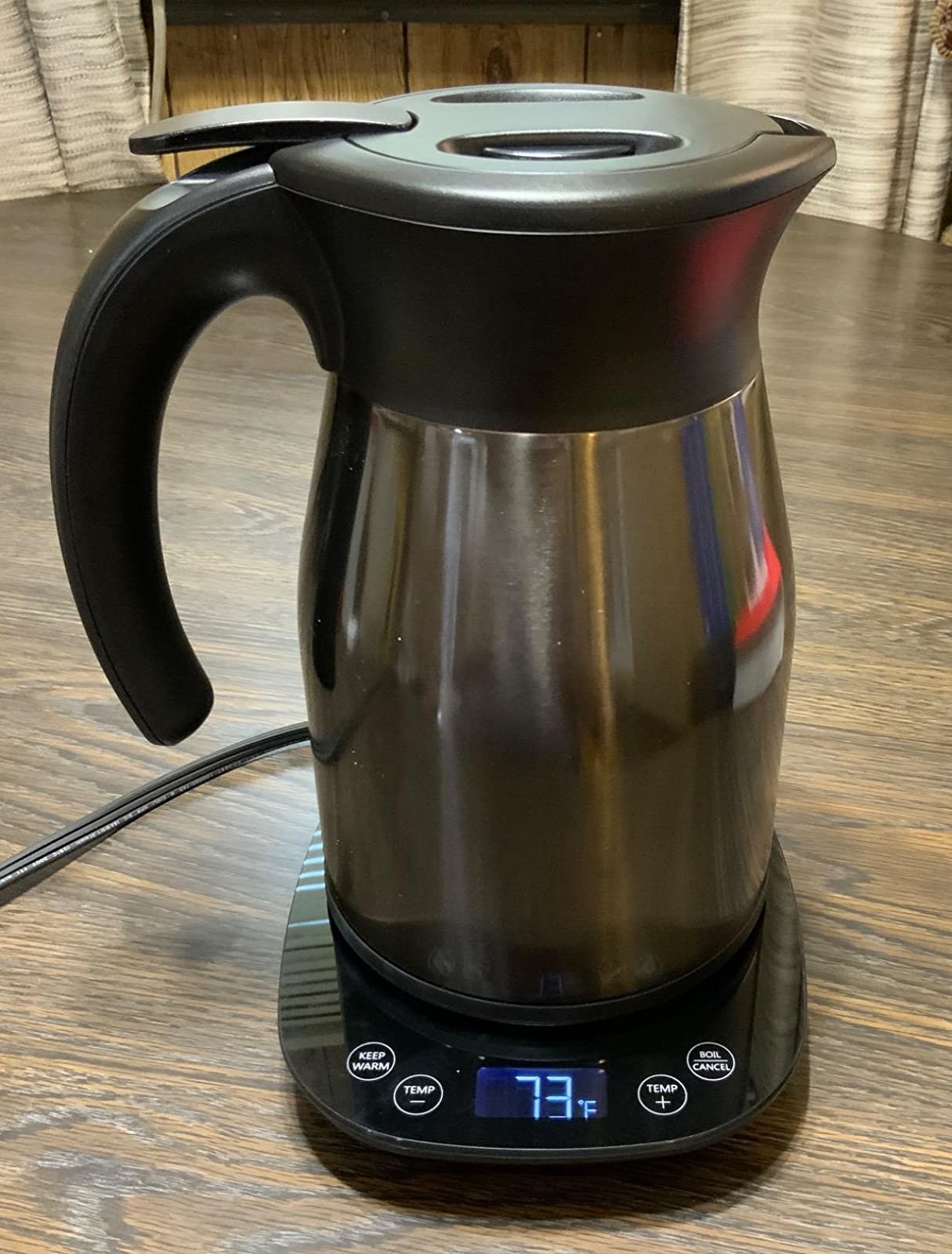 black electric tea kettle with a digital interface that says &quot;73 degrees fahrenheit&quot;