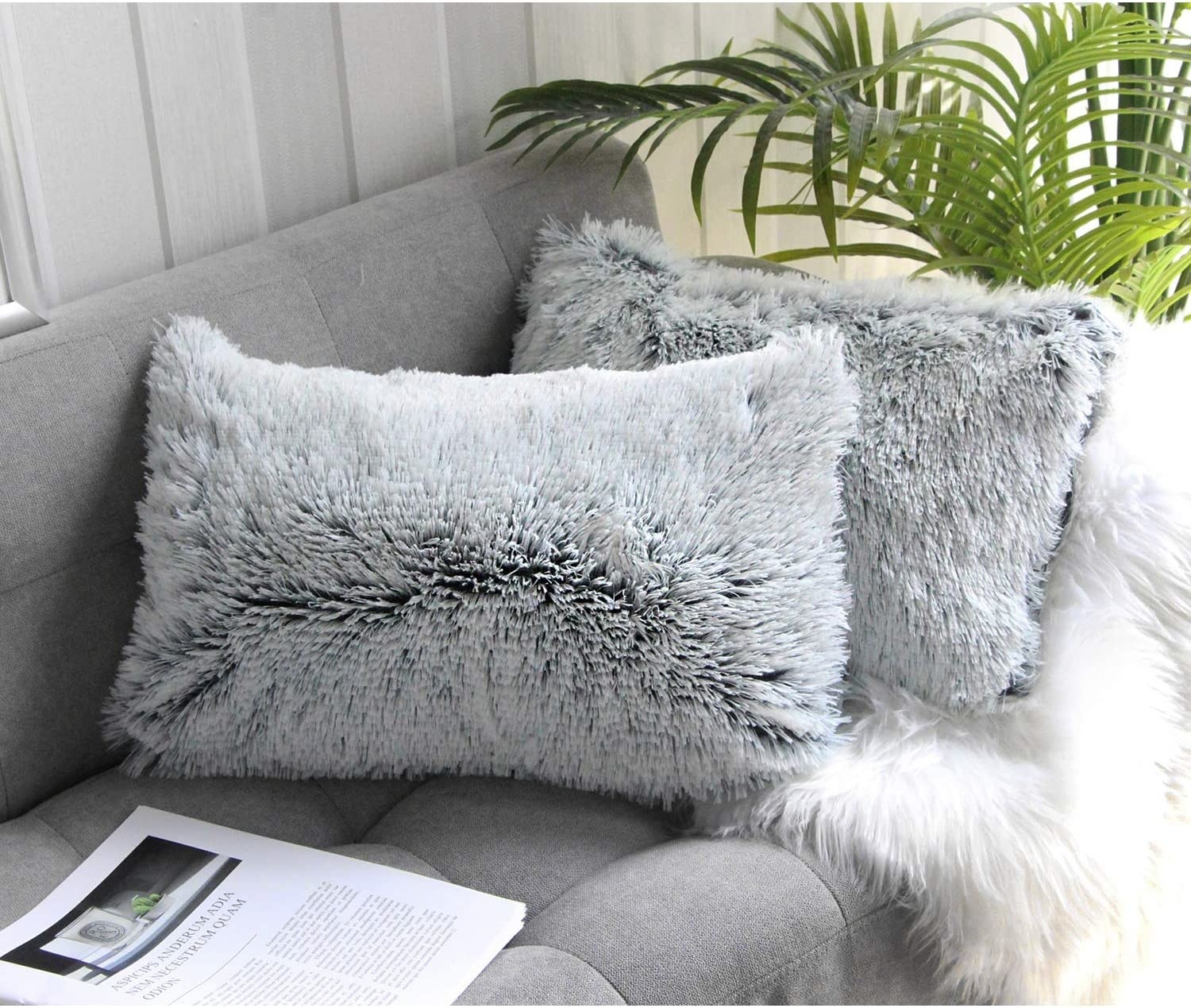 A photo of the gray faux fur pillow covers on rectangular pillows
