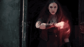 wanda, in a black dress and red jacket, begins using her powers for good