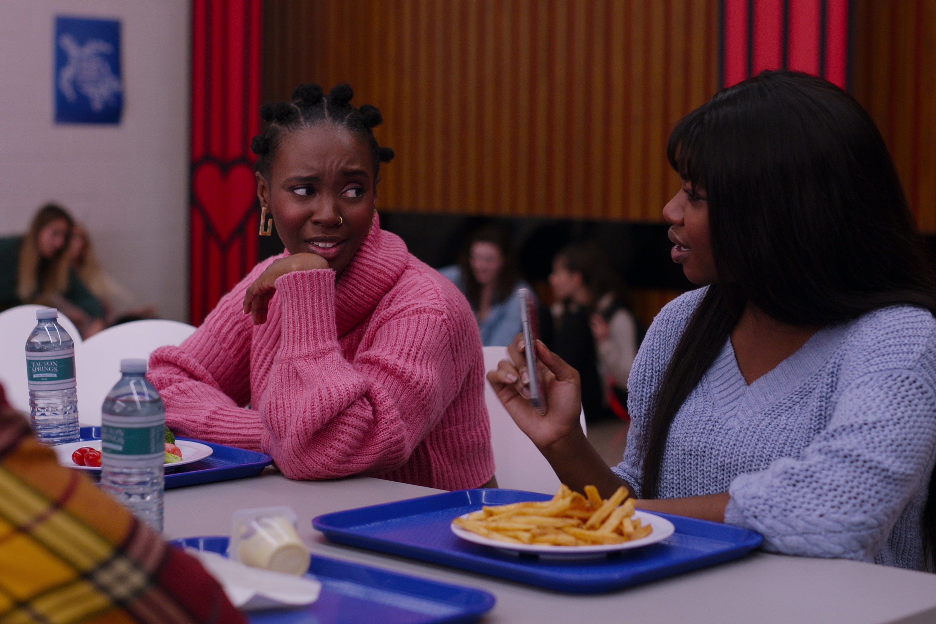 Bracia talks to her friend in the cafeteria