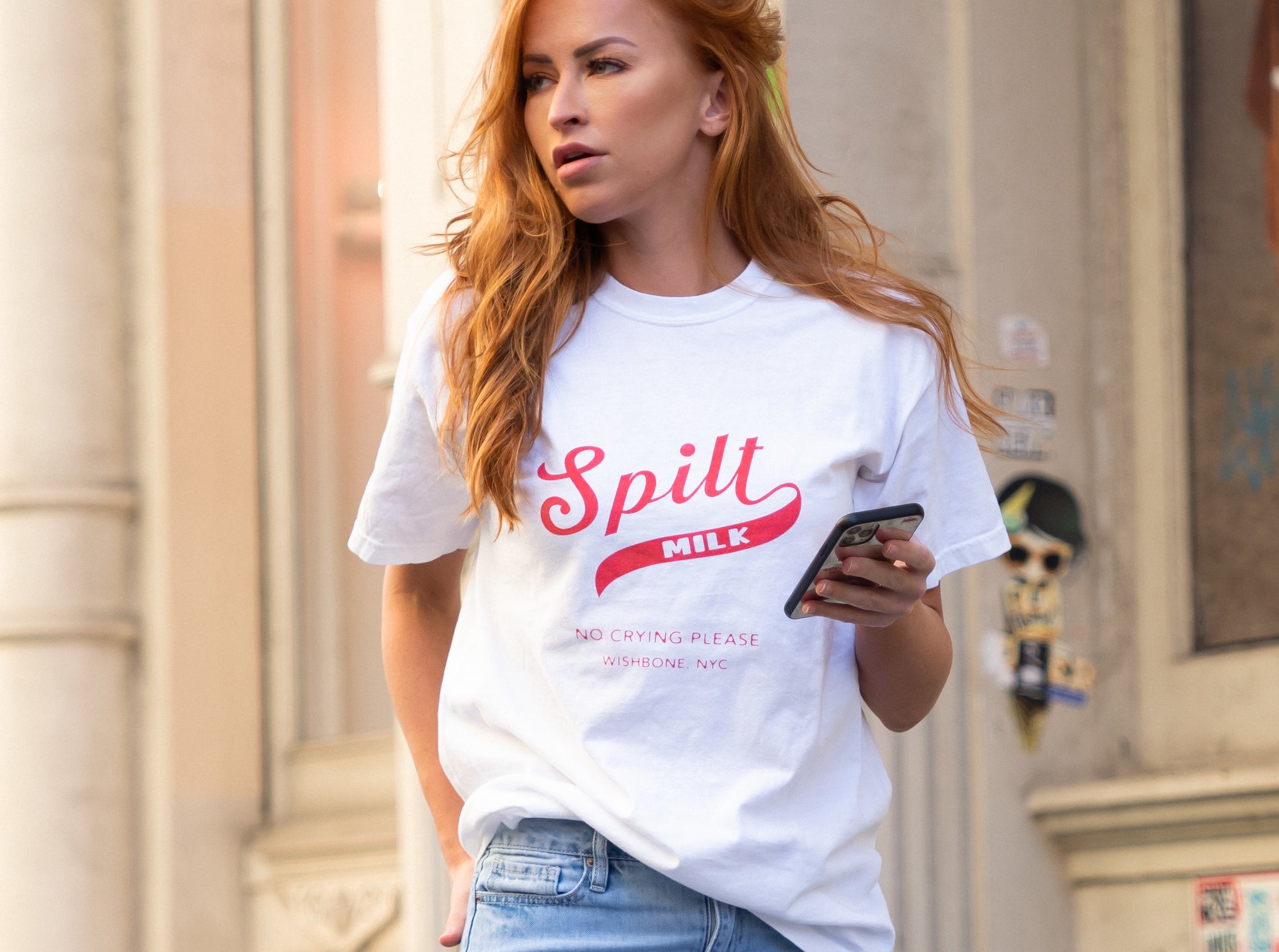 model wearing white t-shirt that says "Spilt Milk No Crying Please"