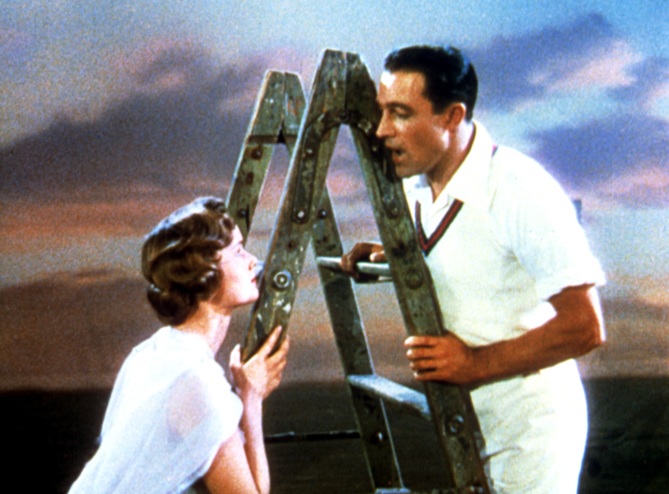 Don and Kathy singing together on a ladder 