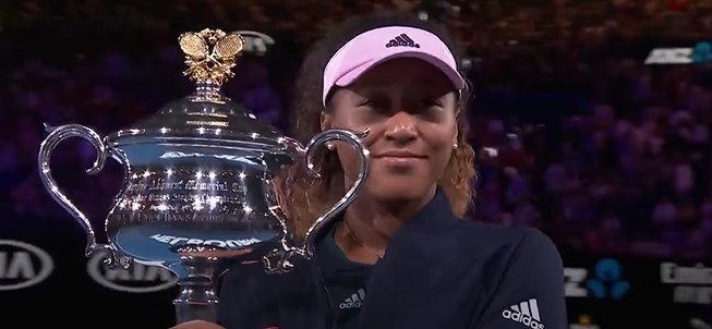 Naomi Osaka holding AO trophy