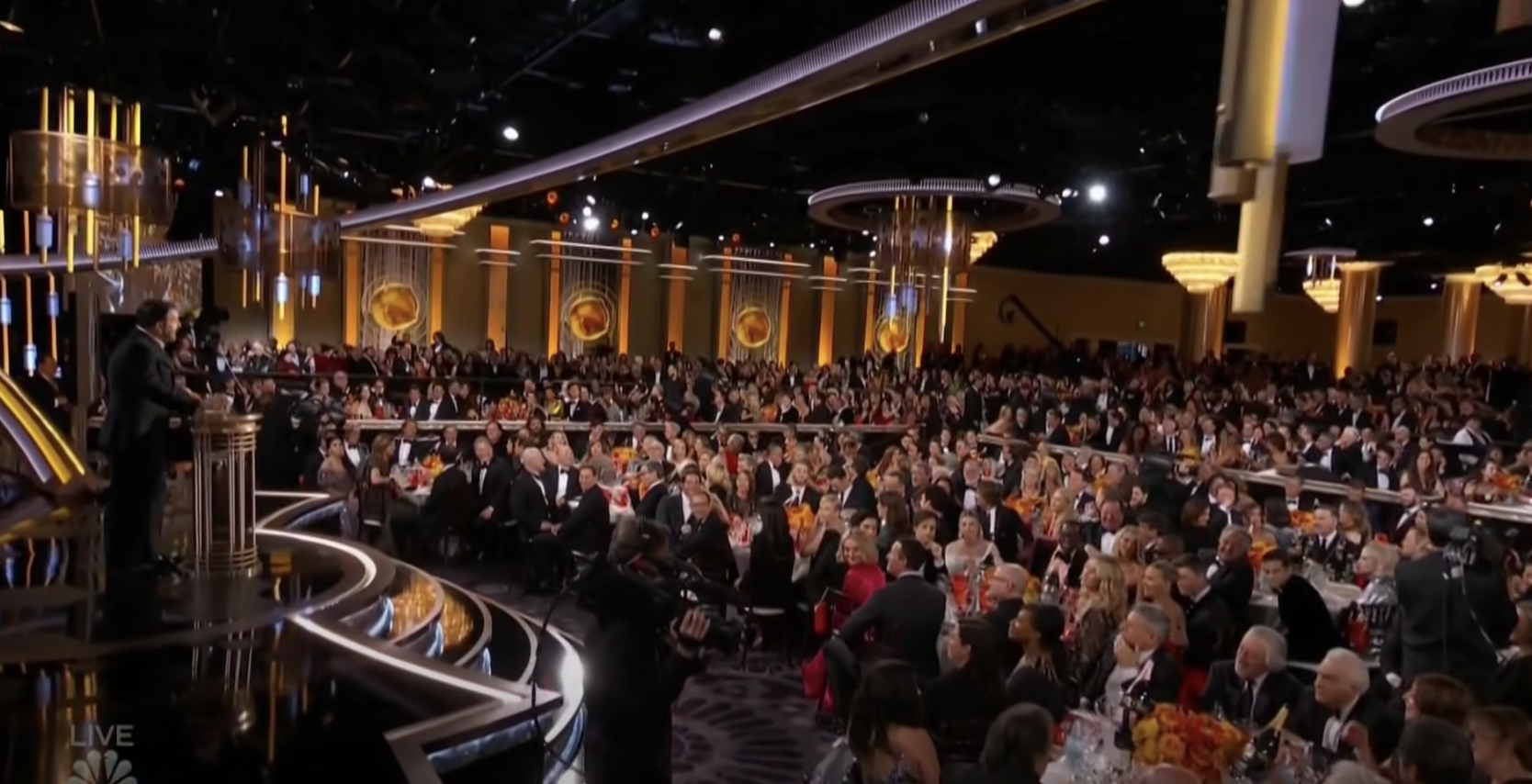 The awards ceremony is filled with celebrities sitting at tables