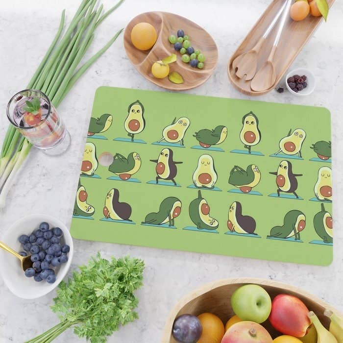 Cutting board with illustrated avocados placed on kitchen counter