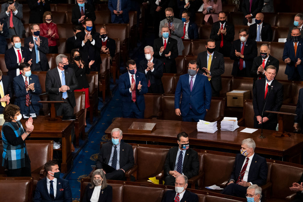 Congressmen standing at a social distance and wearing masks