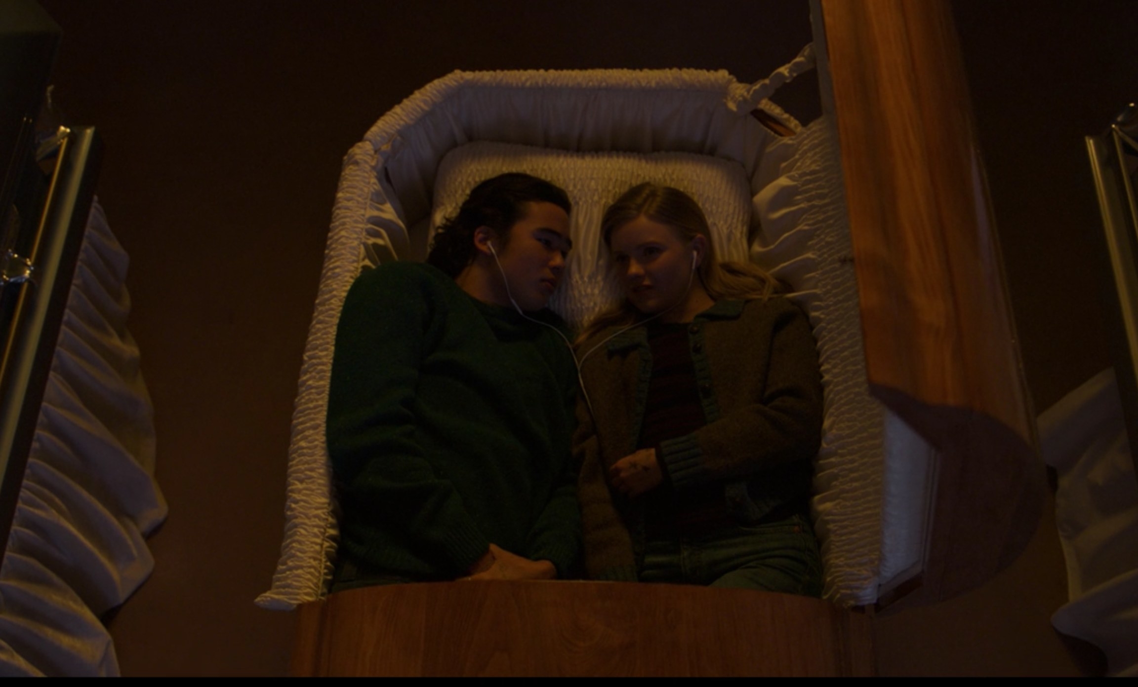 Seth and Viv lie in a coffin together