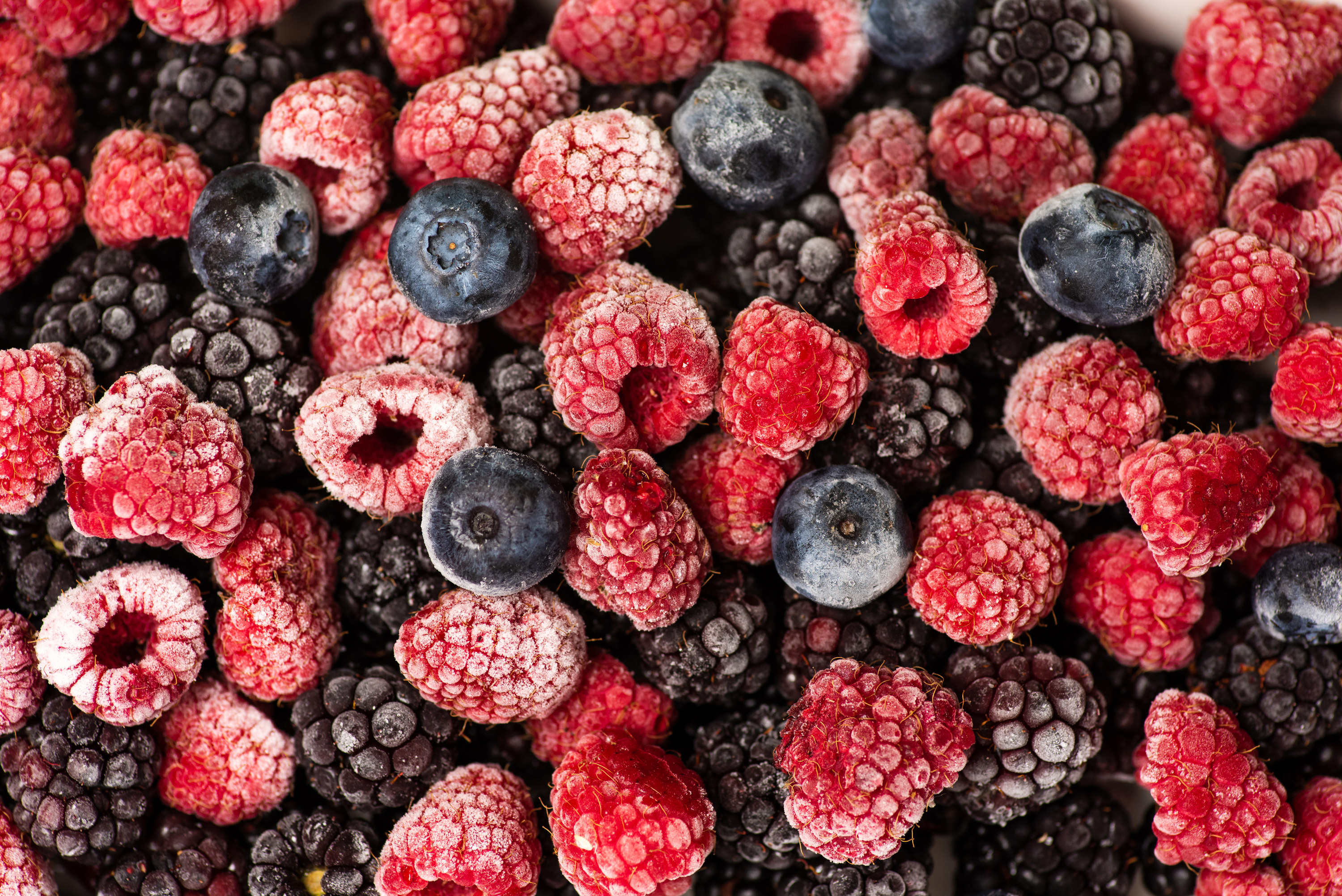 A bunch of frozen berries, including raspberries, blackberries and blueberries 