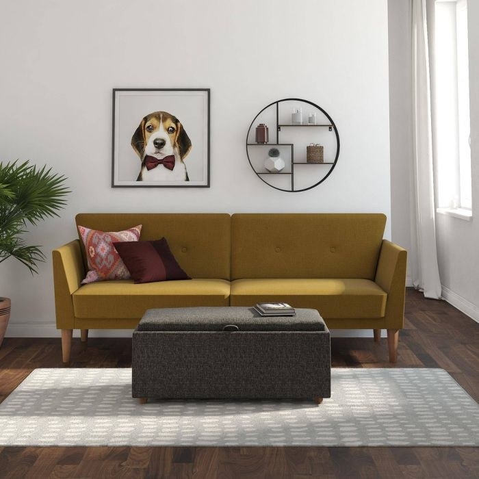 retro, mustard colored sofa with wood legs in a living room