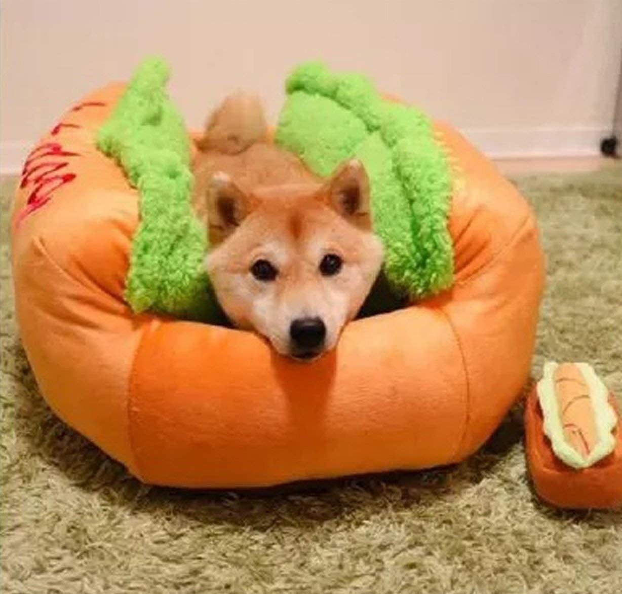 A dog in the bed, lying between the two &quot;bun&quot; sides