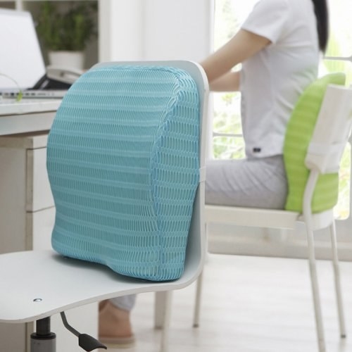 A blue memory foam cushion on an office chair 