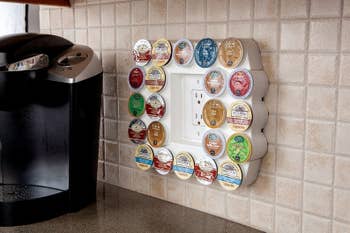 The rectangular organizer around an outlet holding coffee pods