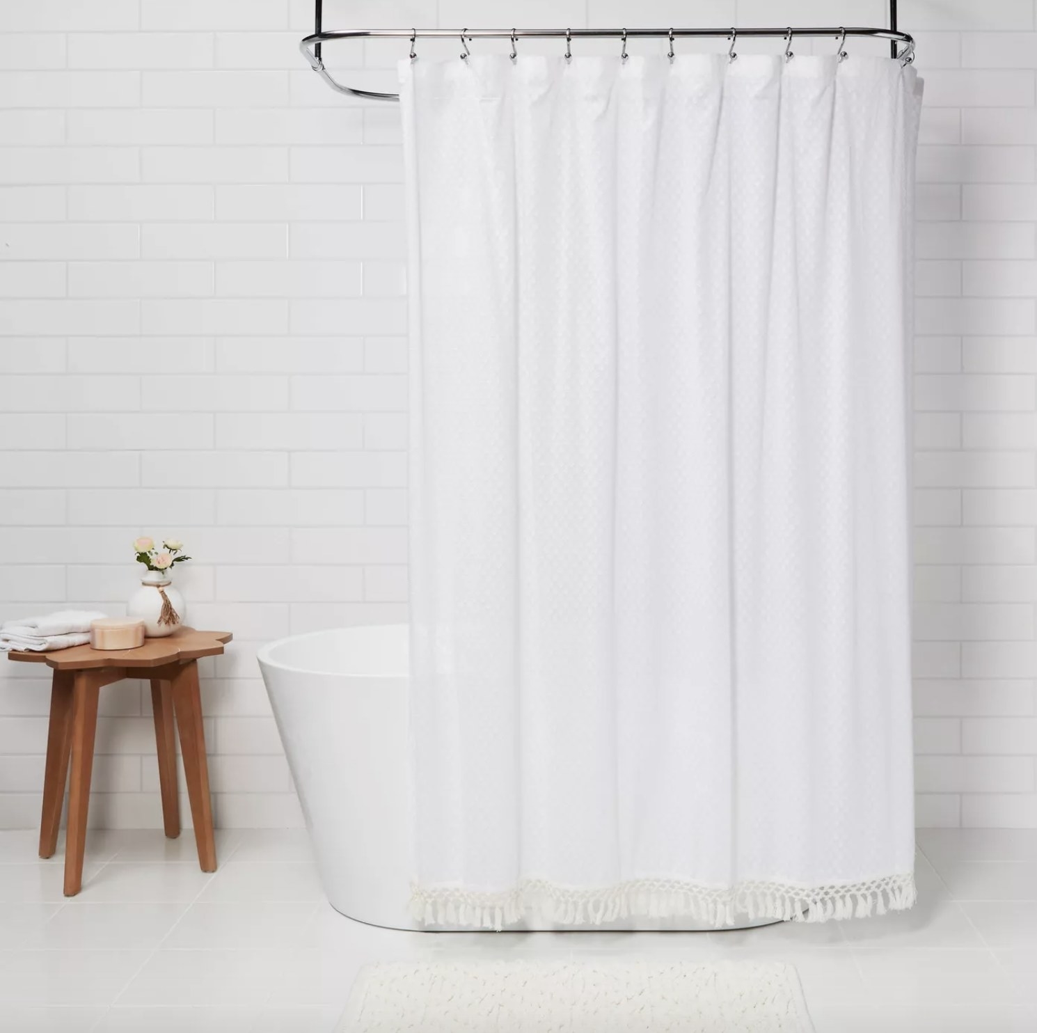 Shower curtain hung on shower rod.