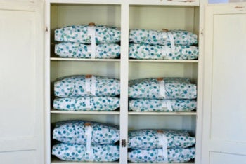 Cupboard with sheets wrapped in Bundle Buddy covers