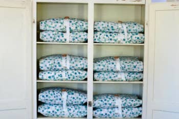 Cupboard with sheets wrapped in Bundle Buddy covers