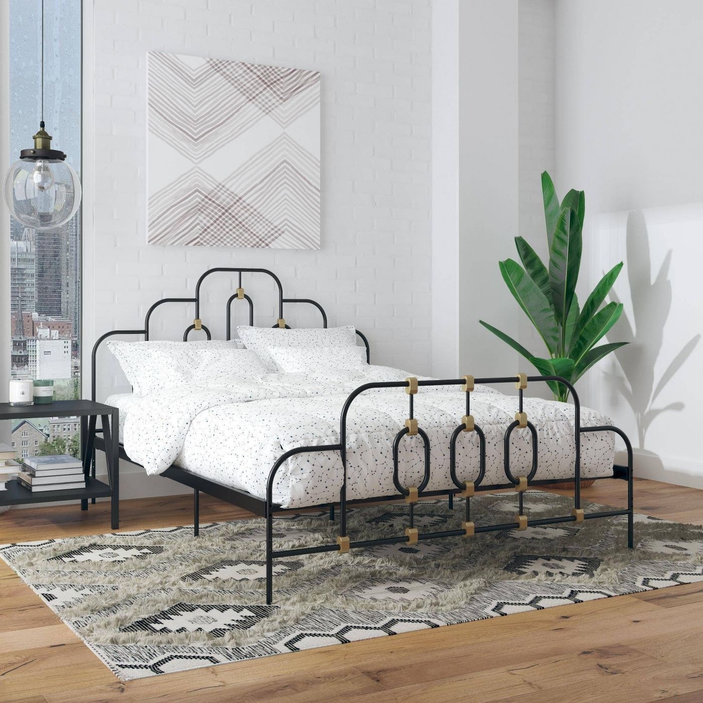 Black and gold bed frame with a white spotted comforter