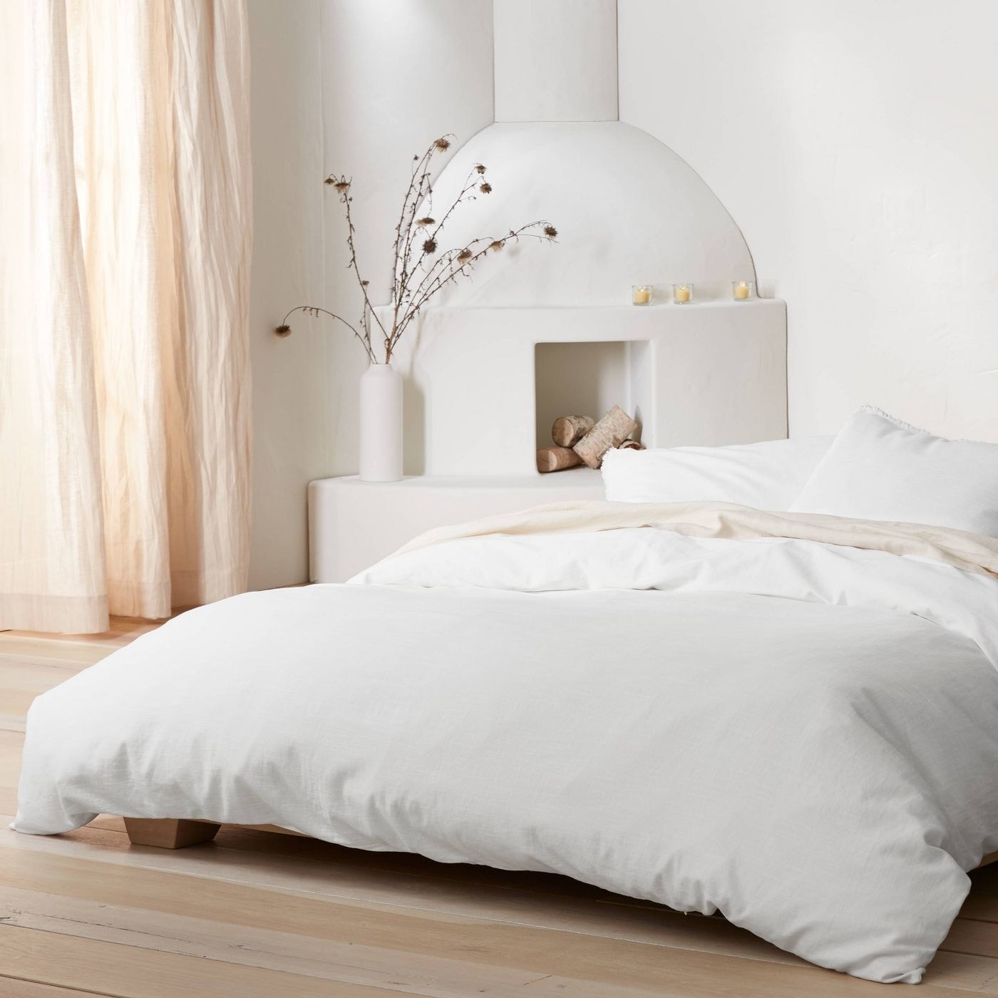 white linen duvet cover and pillow shams on a bed