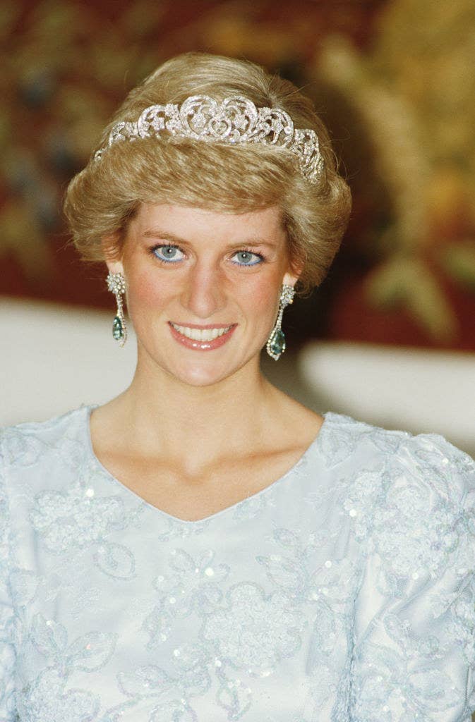 Princess Diana wearing a sequined gown, a tiara, and drop earrings