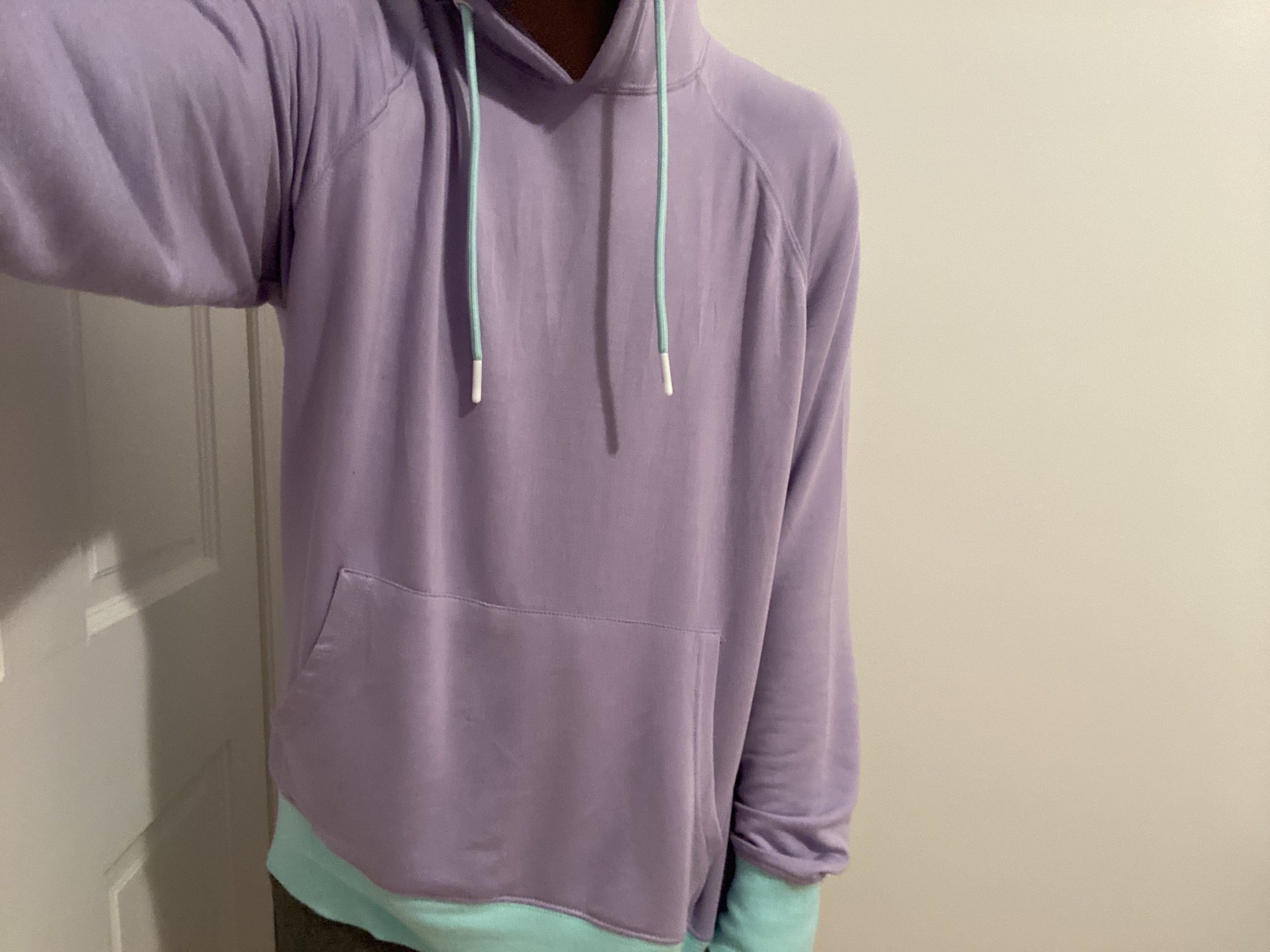 the author wearing the lavender and mint colored hoodie