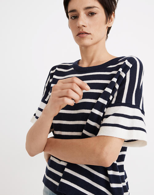 a model wearing the boxy black and white striped shirt