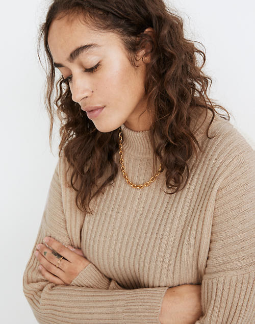 a model wearing the ribbed sweater in heather beige color