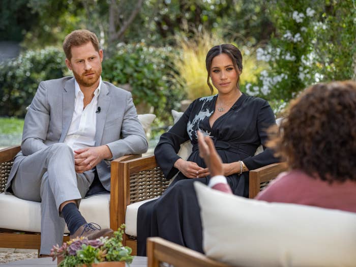 Prince Harry and Meghan Markle sit next to each other during their interview with Oprah