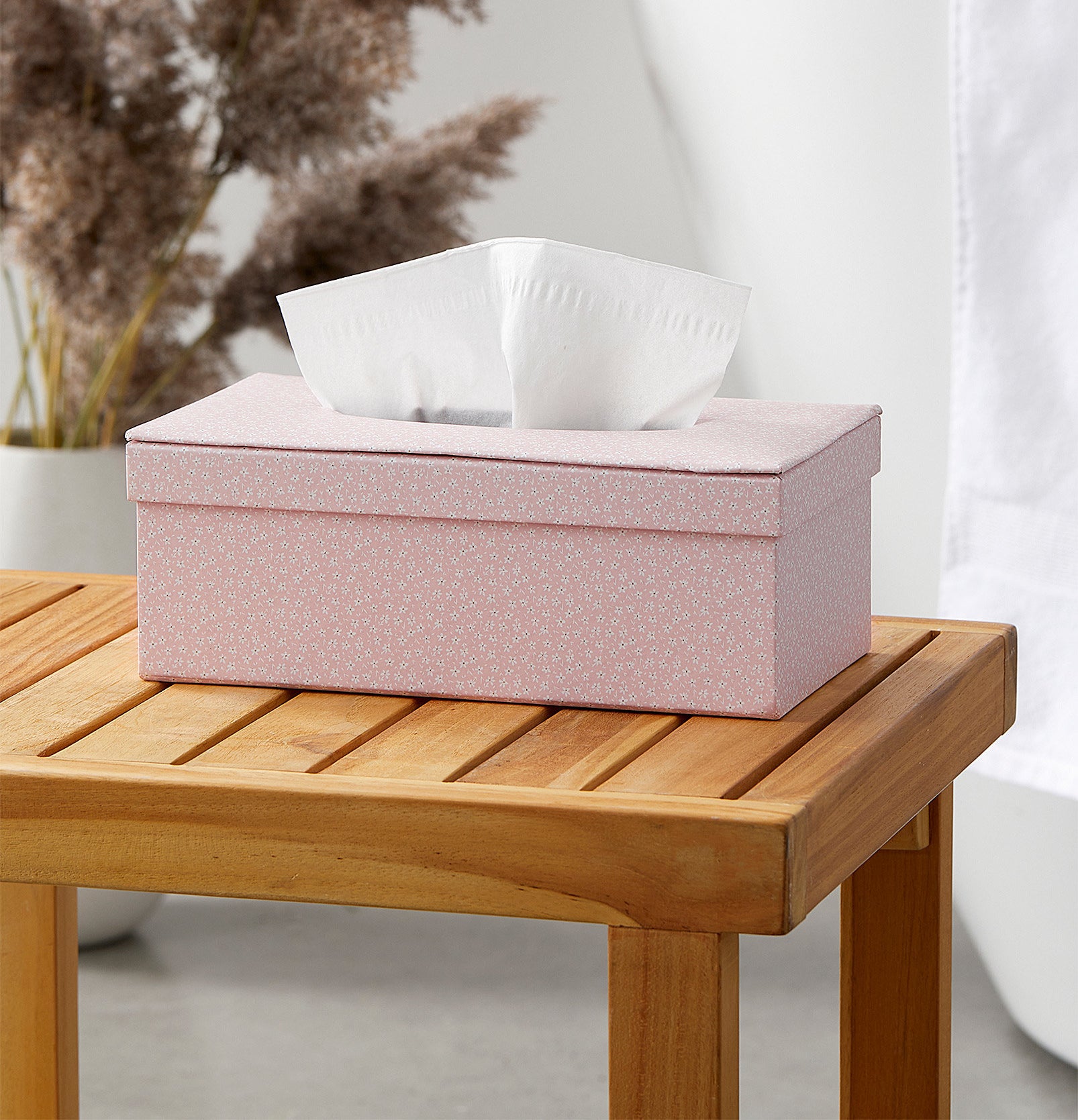 A tissue box on a wooden stool