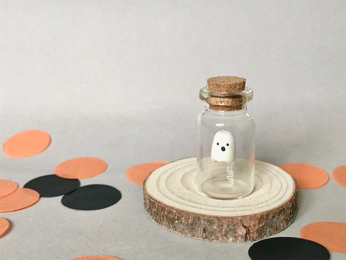 small bottle with hovering ghost inside 