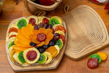 Apple shaped tray with several slices of dried fruit on top 